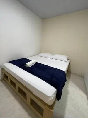 a bed with two pillows and a blue blanket at Hotel Casablanca in Galapa