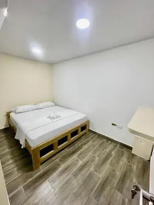 a bedroom with a bed in a room with wooden floors at Hotel Casablanca in Galapa