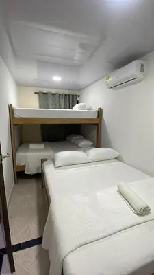 a room with three bunk beds in it at Hotel Casablanca in Galapa