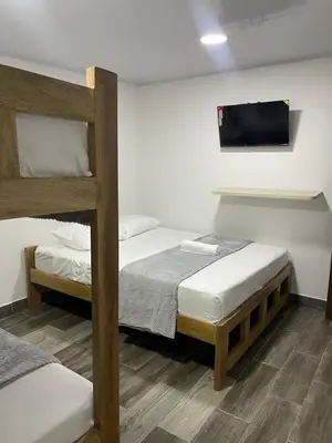 a bedroom with two bunk beds and a flat screen tv at Hotel Casablanca in Galapa