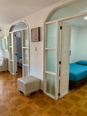 a bedroom with a bed and a ottoman in a room at apartamento con vista al Lago in Cartagena de Indias