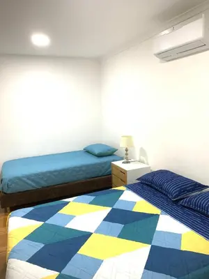 a bedroom with two beds with a colorful blanket at apartamento con vista al Lago in Cartagena de Indias