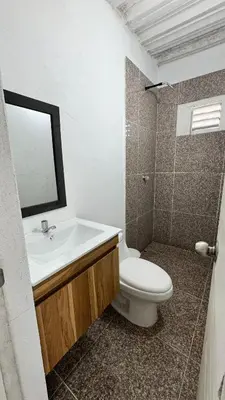 a bathroom with a sink and a toilet and a mirror at Cabañas en Cartagena JhonliMar in Isla de Tierra Bomba