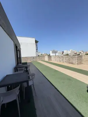 a row of tables and chairs on the roof of a building at Espectacular Apartamento Amoblado - 2 Habitaciones in Barranquilla