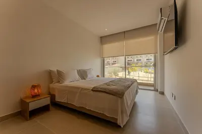 a bedroom with a large bed and a window at Baia Kristal Cartagena in Cartagena de Indias