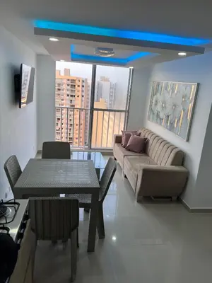a living room with a couch and a table at Cozy apartment in the heart of Barranquilla in Barranquilla