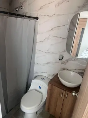 a bathroom with a white toilet and a sink at Cozy apartment in the heart of Barranquilla in Barranquilla