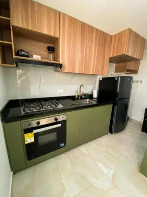 a kitchen with a stove and a refrigerator at Apartamento Sabaii 201 in Cartagena de Indias
