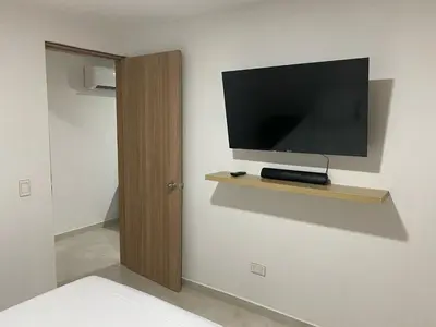 a flat screen tv on a wall in a room at Apartamento Sabaii 201 in Cartagena de Indias