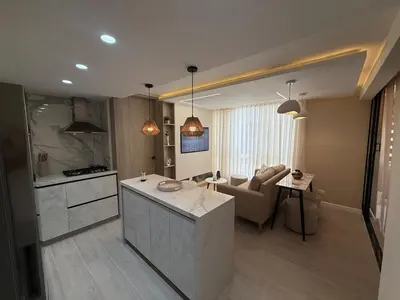 a kitchen and living room with a couch and a table at Open Floor Chic Interior Design Pool Full Kitchen in Barranquilla