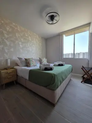 a bedroom with a bed with a fan and a window at Open Floor Chic Interior Design Pool Full Kitchen in Barranquilla