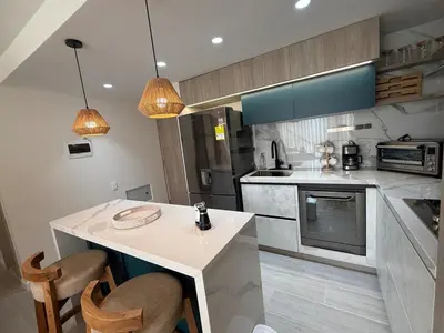 a kitchen with a counter and some chairs in it at Open Floor Chic Interior Design Pool Full Kitchen in Barranquilla