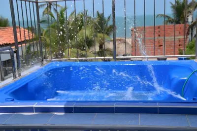 a swimming pool with a water fountain at Cabaña AveMaria in Coveñas