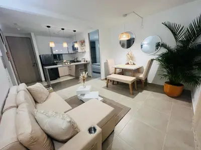 a living room with a couch and a dining room at Apartamento Descanso Cartagena in Manzanillo del Mar