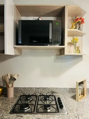 a microwave oven above a stove in a kitchen at Apartamento Descanso Cartagena in Manzanillo del Mar