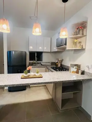 a kitchen with white cabinets and a large counter top at Apartamento Descanso Cartagena in Manzanillo del Mar