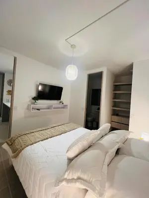 a bedroom with two white beds and a tv at Apartamento Descanso Cartagena in Manzanillo del Mar