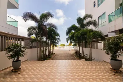 a hallway with palm trees in a building at Magico Apartamento Frente al Mar 3 Habitaciones AR12 in Coveñas