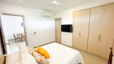 a bedroom with a bed and a couch and a tv at Magico Apartamento Frente al Mar 3 Habitaciones AR12 in Coveñas