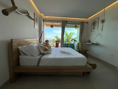a bedroom with a bed with a view of the ocean at Despierta en Tolú, un escenario de película in Tolú