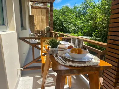 a wooden table with a bowl of fruit on a balcony at Despierta en Tolú, un escenario de película in Tolú