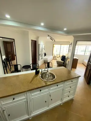 a bathroom with a sink and a living room at Cabrero Beach 1008 in Cartagena de Indias