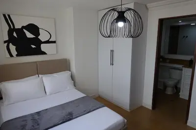 a bedroom with a bed and a pendant light at Cabrero Beach 1008 in Cartagena de Indias