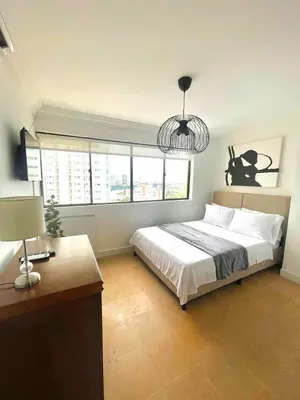 a bedroom with a bed and a table and a lamp at Cabrero Beach 1008 in Cartagena de Indias