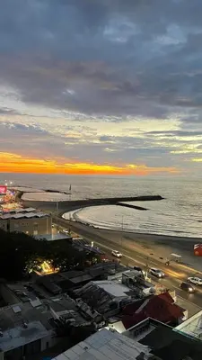 a view of a beach and the ocean at sunset at Cabrero Beach 1008 in Cartagena de Indias