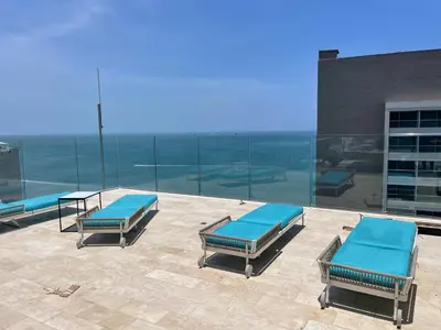 two lounge chairs and a table on top of a building at sui lofts 1609 in Santa Marta