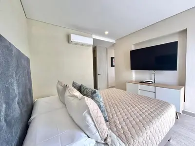 a bedroom with a bed and a flat screen tv at Martinique 1001 luxure escape & comfort in Cartagena de Indias