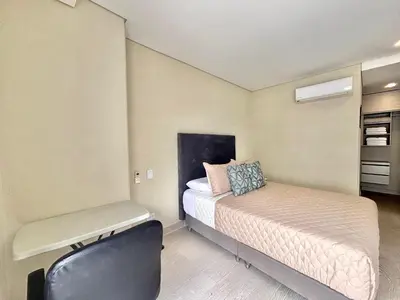 a small bedroom with a bed and a chair at Martinique 1001 luxure escape & comfort in Cartagena de Indias