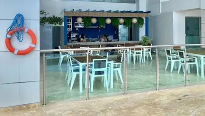 a restaurant with white chairs and tables and a clock at Inolvidables atardeceres en Cartagena in Cartagena de Indias