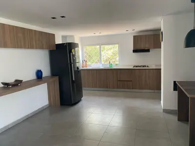 a kitchen with a black refrigerator in a room at Apartamentos en Bocagrande frente al mar in Cartagena de Indias