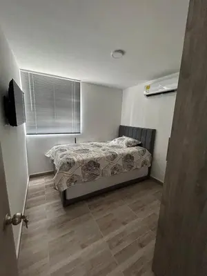 a small bedroom with a bed and a window at Apartamento en Barranquilla in Puerto Colombia