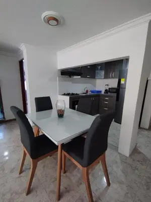 a dining room table with chairs and a kitchen at PrinSha#2 in Cartagena de Indias