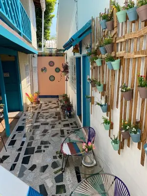 an outdoor patio with a table and chairs and potted plants at Apartaestudios Ofir in Barranquilla