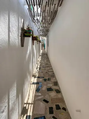 a hallway with a tile floor in a building at Apartaestudios Ofir in Barranquilla