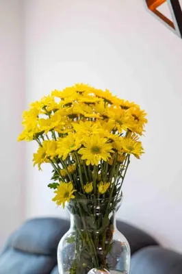 a glass vase filled with yellow flowers on a table at Luxury CTG Condo Near Beach Cold AC & Hot Water in Cartagena de Indias