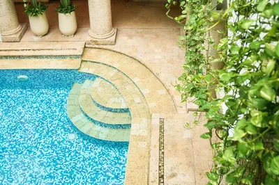 a swimming pool with blue tiles on the ground at Hotel Boutique Patio Corao in Cartagena de Indias