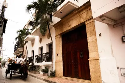 a horse drawn carriage in front of a building at Hotel Boutique Patio Corao in Cartagena de Indias