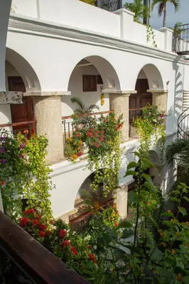 a building with flowers on the side of it at Hotel Boutique Patio Corao in Cartagena de Indias