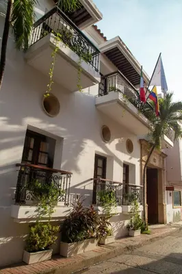 a white building with balconies and potted plants at Hotel Boutique Patio Corao in Cartagena de Indias