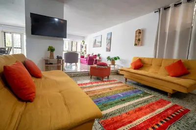 a living room with two couches and a flat screen tv at Casa Caribe, excellent location in Bocagrande in Cartagena de Indias