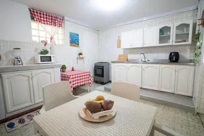 a kitchen with a table with a bowl of fruit on it at Casa Caribe, excellent location in Bocagrande in Cartagena de Indias