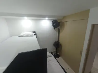 a small room with a bed and a fan at aqualina911 in Cartagena de Indias