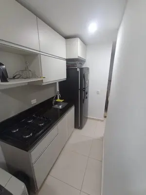 a kitchen with a black refrigerator and white cabinets at aqualina911 in Cartagena de Indias