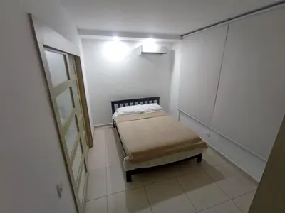 a small room with a bed and a mirror at aqualina911 in Cartagena de Indias