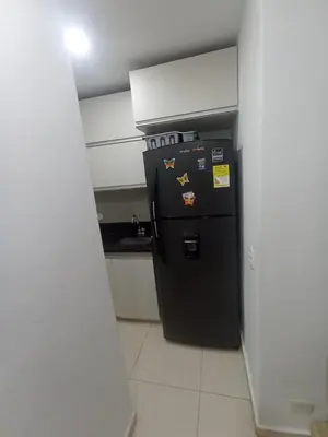 a black refrigerator in a kitchen with a counter at aqualina911 in Cartagena de Indias
