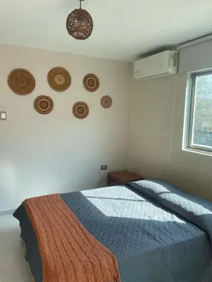 a bedroom with a bed and a window and plates on the wall at Luxury cabin in Santa Veronica in Santa Veronica